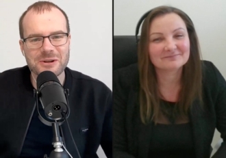 Two people appear in a split-screen video call: a man with glasses and a mic on the left, a smiling woman with a headset on the right.
