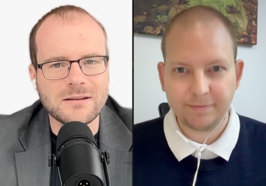 Split-screen video call with two men: left man wearing glasses speaks into a microphone, right man in a white-collared shirt listens with earphones