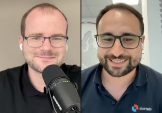 Two men split-screen on a video call; left man speaks into a microphone with AirPods, right man smiles wearing glasses and a dark polo with a logo.